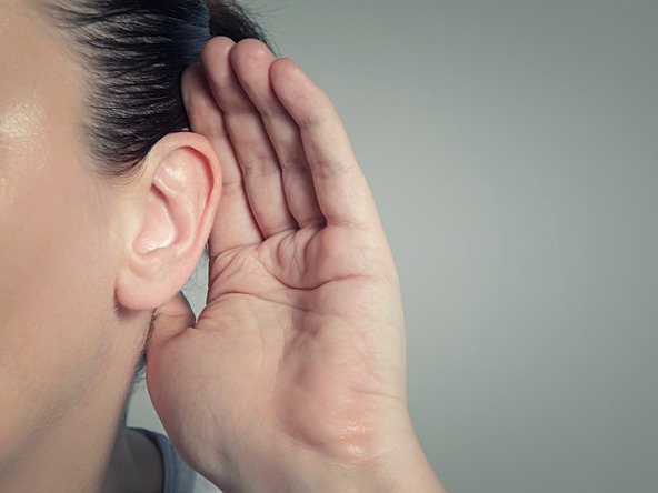 woman with hand cupped to ear